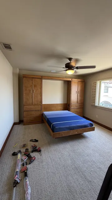 Built-in wall bed with side cabinets
